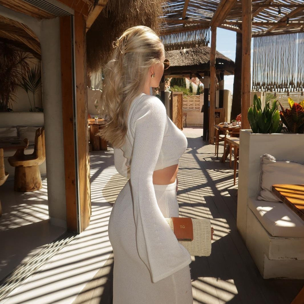 woman holding personalised woven bag at a beach club