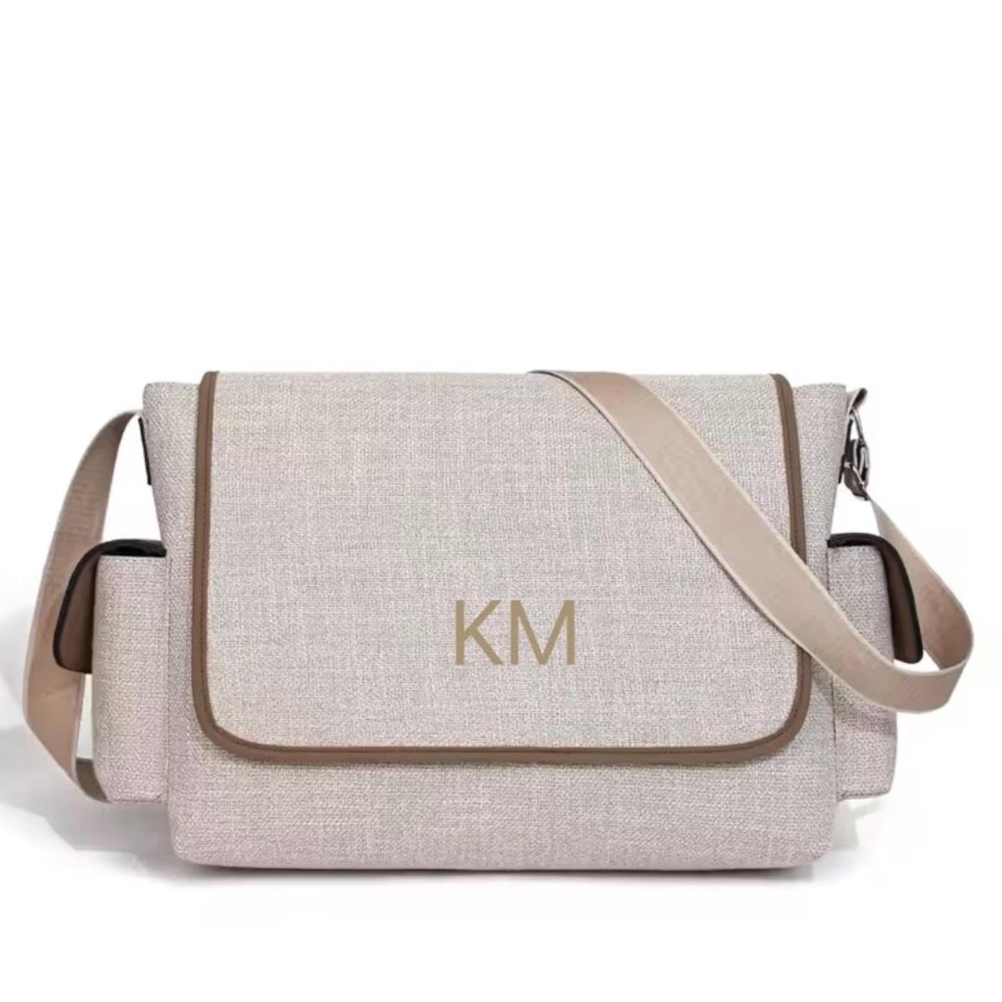 Beige shoulder bag with 'KM' monogram on a white background