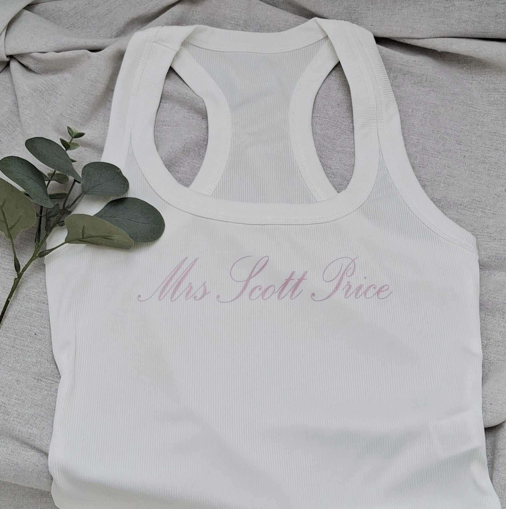 White tank top with 'Mrs. Scott Price' text on a gray fabric background