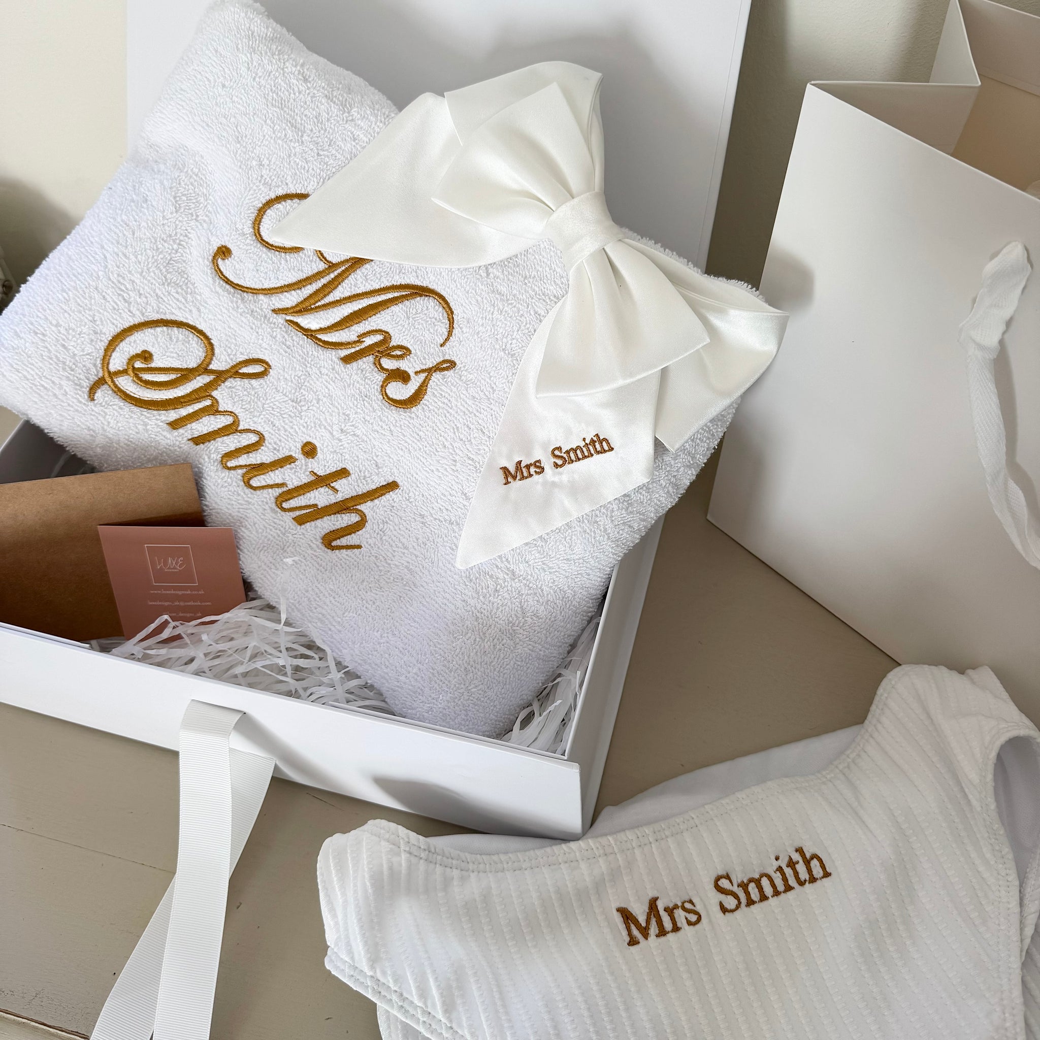 White towels with 'Mrs Smith' embroidery in a box