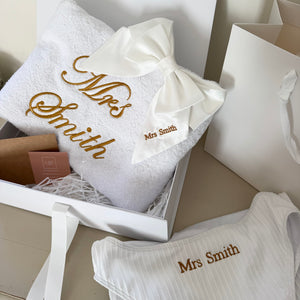White towels with 'Mrs Smith' embroidery in a box