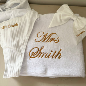 white personalised bridal towel with matching bow and swimsuit