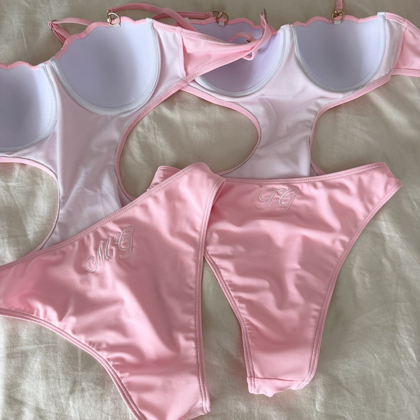 Pink bikini set on a light gray background