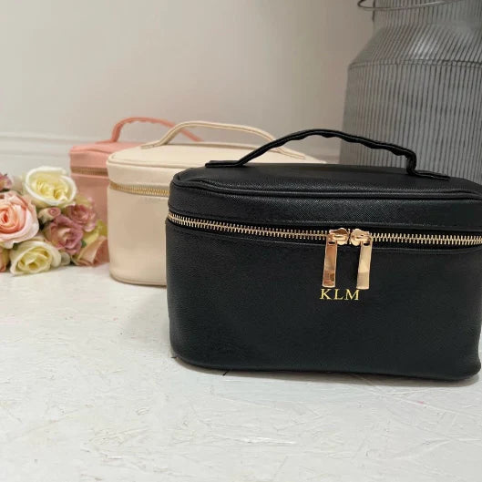 Black cosmetic bag with gold zipper and 'KLM' monogram