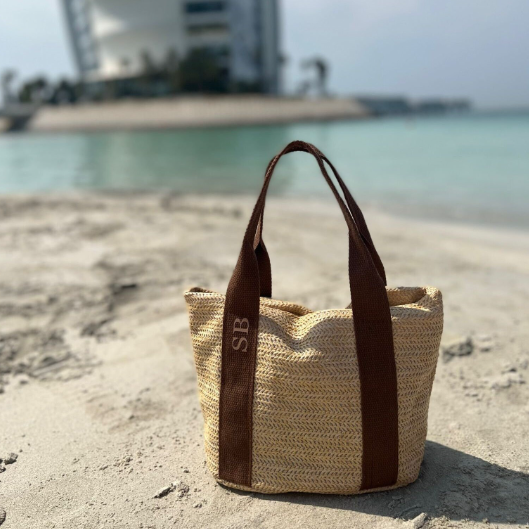 personalised mini tote bag on the beach with the sea in the background
