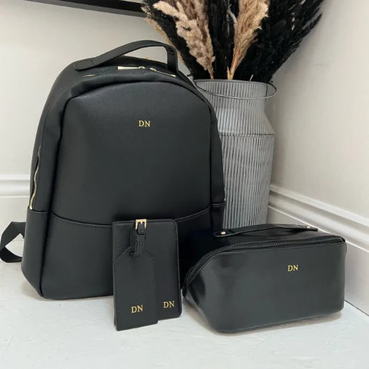 Black backpack  with 'DN' initials 