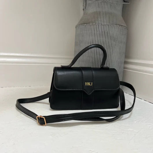 Black handbag with 'HKJ' initials
