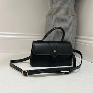 Black handbag with 'HKJ' initials