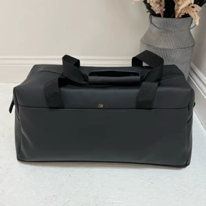 Black travel bag with 'JB' from different angle