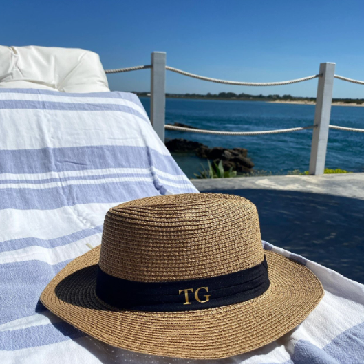 Personalised Beach Hat on sunlounger by the sea