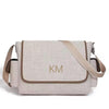 Beige shoulder bag with 'KM' monogram on a white background
