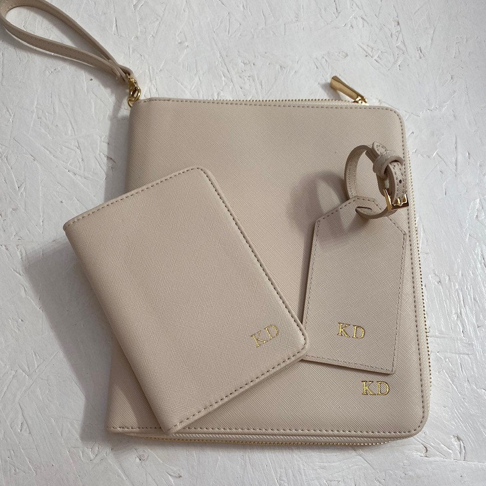 Personalised travel document wallet in beige. Image shows the product with a matching passport holder and luggage tag