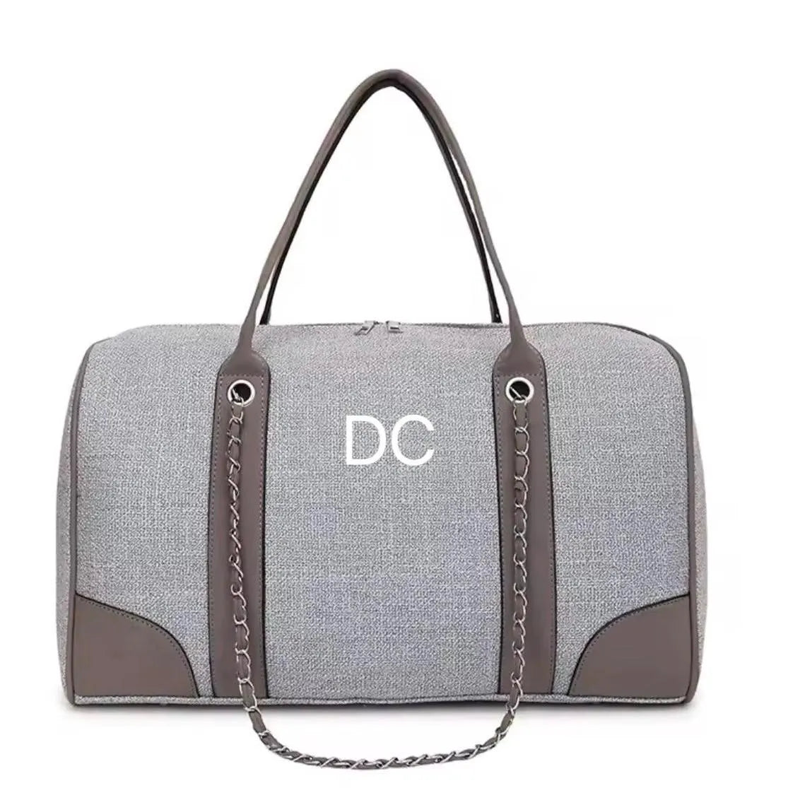 Grey duffel bag with brown accents and 'DC' logo on a white background