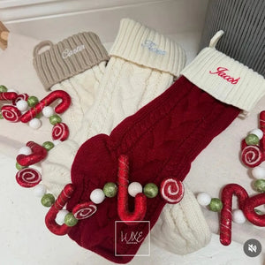 Three Christmas stockings with candy decorations on a white background, all personalised.