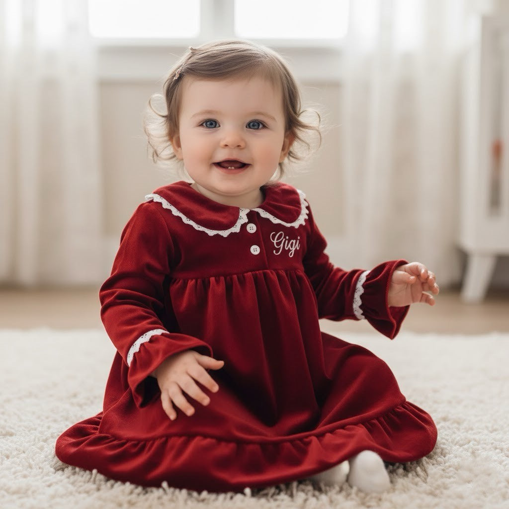 baby girl wearing red velvet dress with the name gigi on it