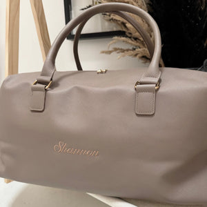 Beige handbag with 'Shannon' branding on a neutral background