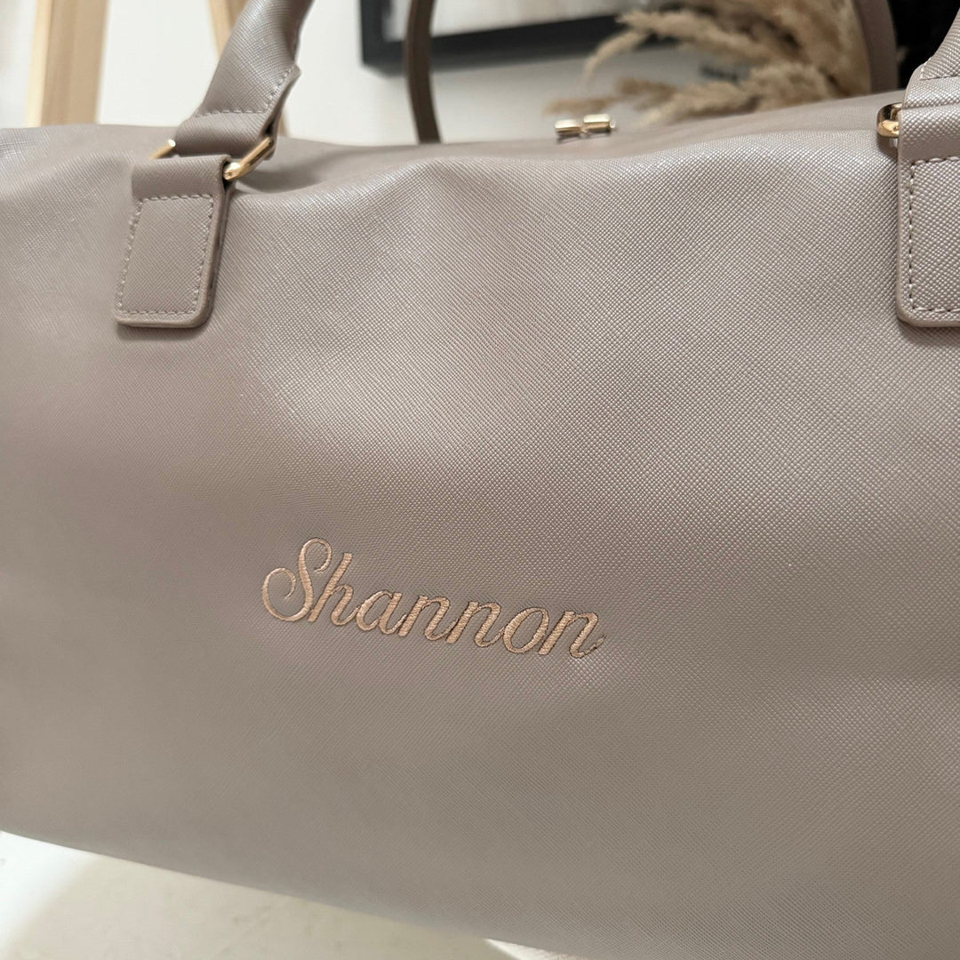 Gray handbag with 'Shannon' embossed on it, on a light background