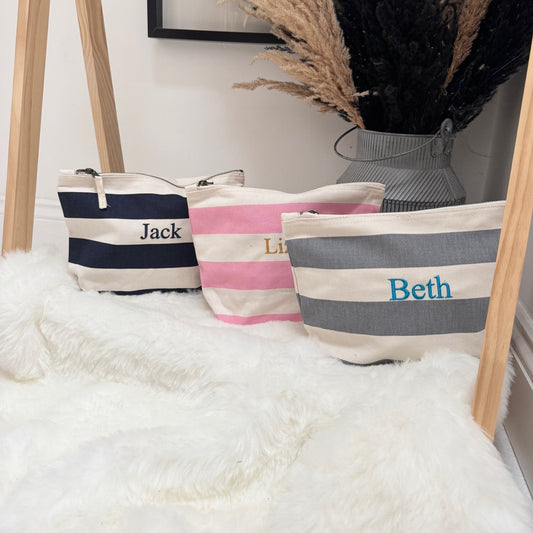 Three striped bags with names 'Jack', 'Lily', and 'Beth' on a white surface with decorative elements.
