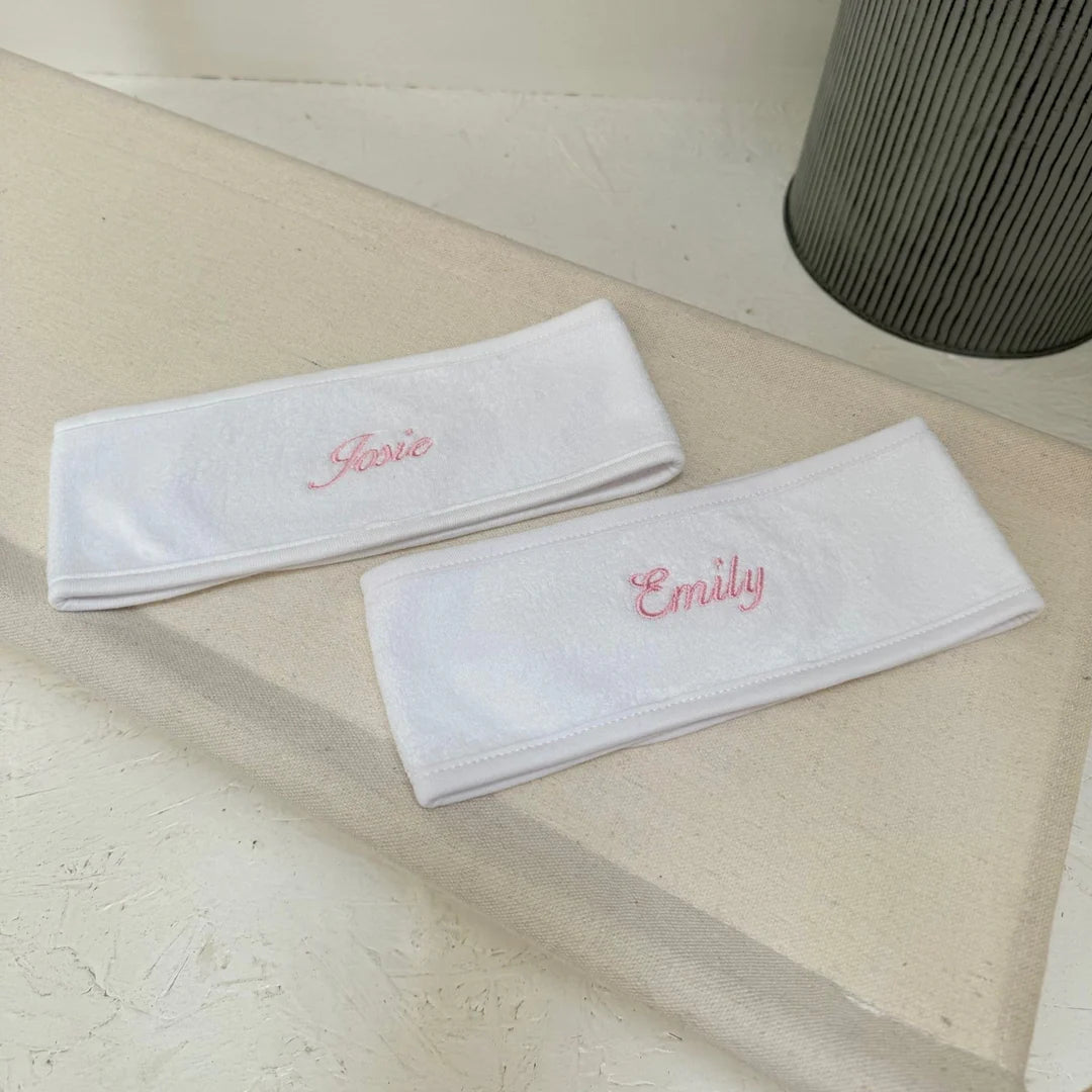 two white spa headbands with personalised names on
