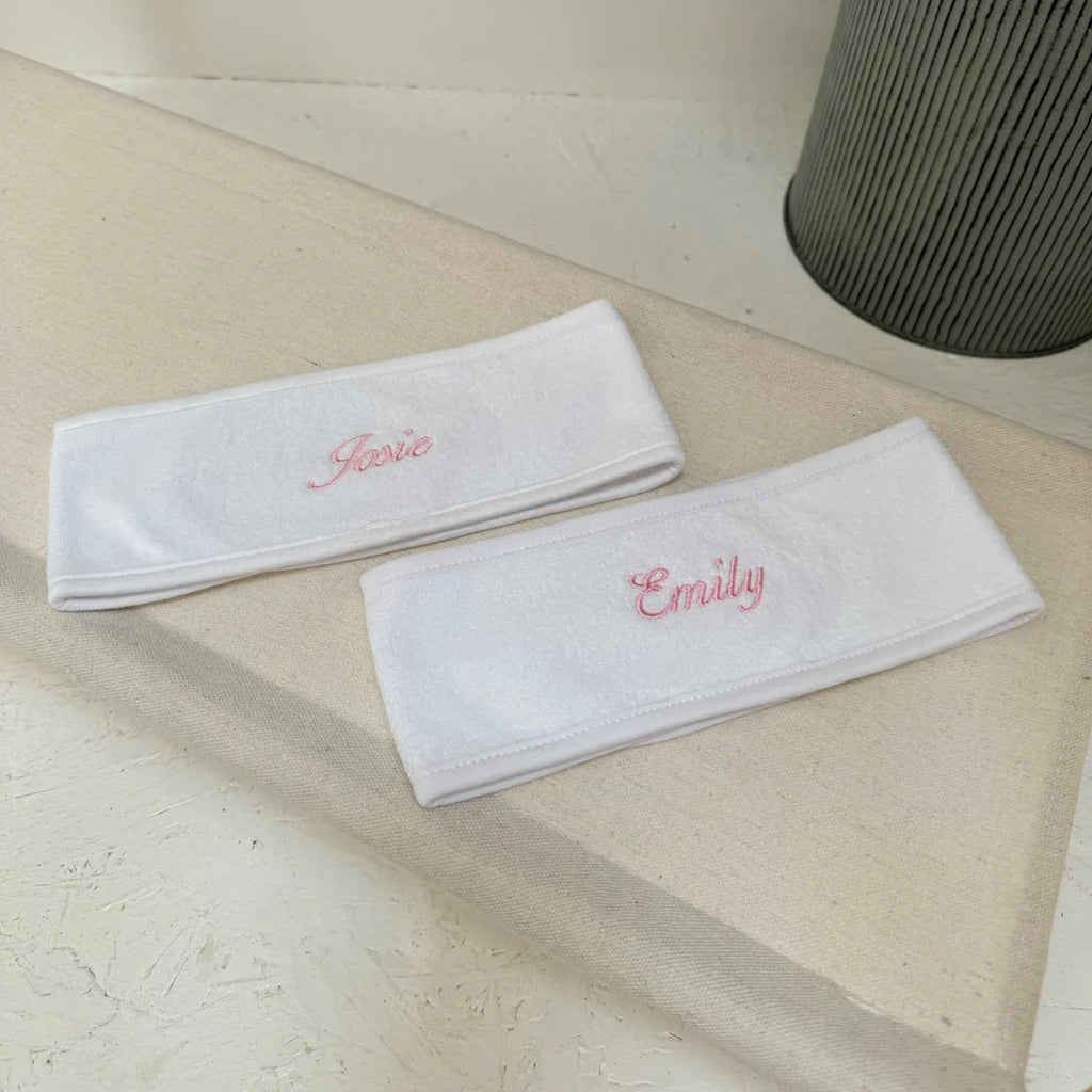 two white spa headbands with personalised names on