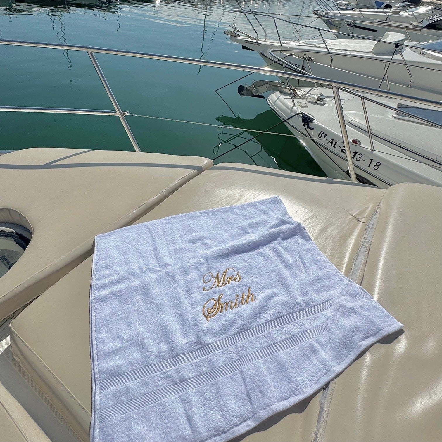 white  towel with 'Mrs. Smith' embroidery on a boat deck