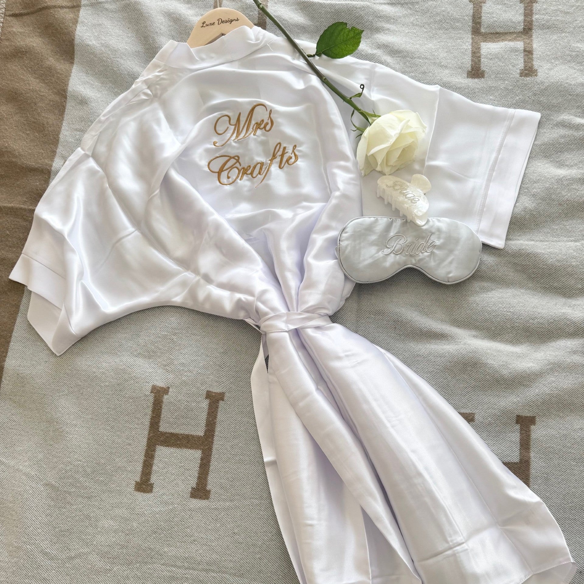 White robe with 'Mrs. Craft's' embroidery on a textured surface.