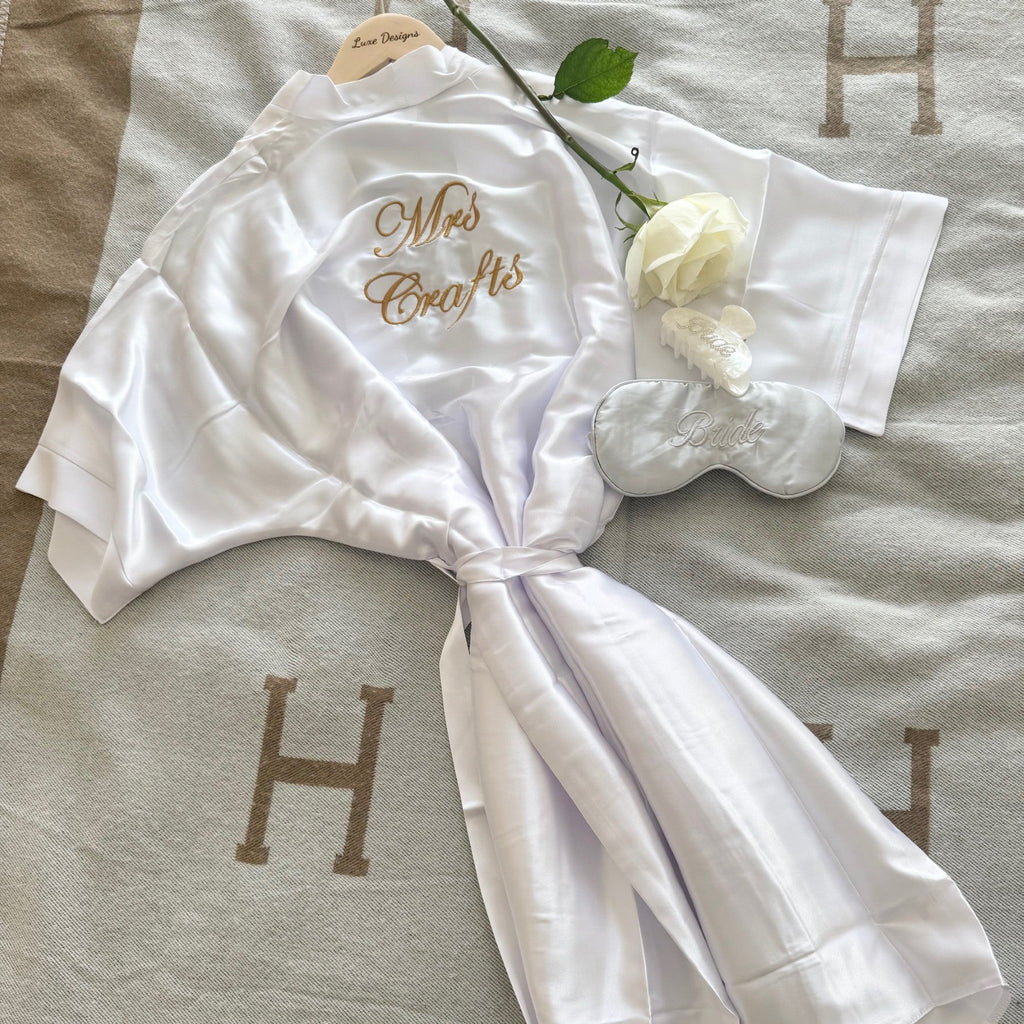 White robe with 'Mrs. Craft's' embroidery on a textured surface.