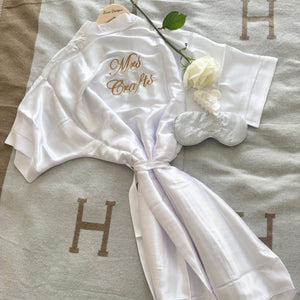White robe with 'Mrs. Craft's' embroidery on a textured surface.