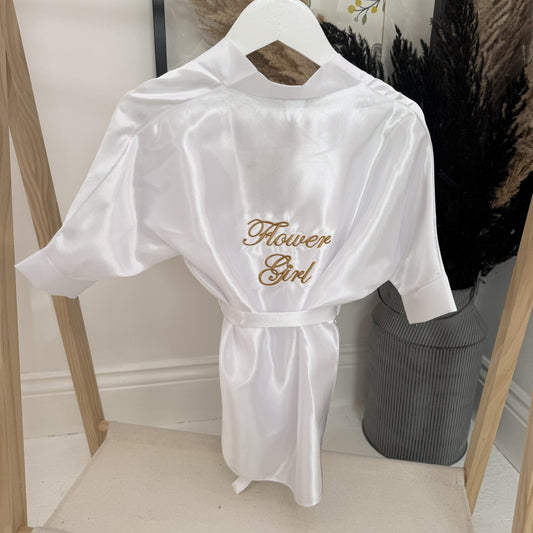 White robe with 'Flower Girl' embroidery on a hanger against a neutral background.