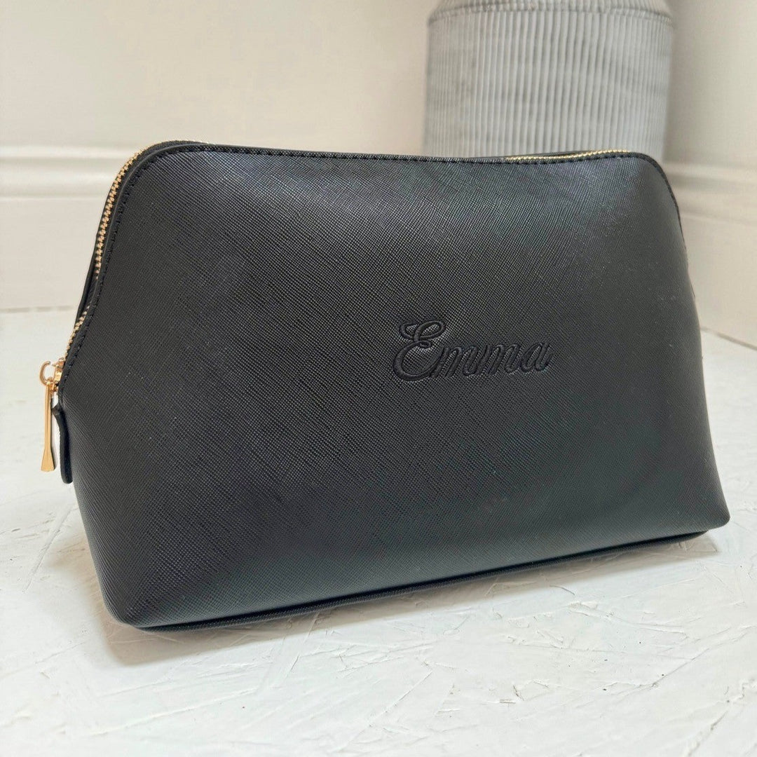 Black wash bag with 'Emma' personalised on a light background