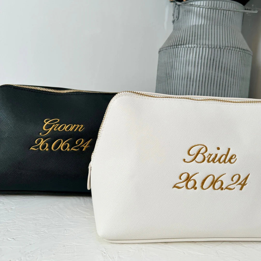 Black wash bag with groom and date on it and white wash bag with bride and date on it. Both embroidered