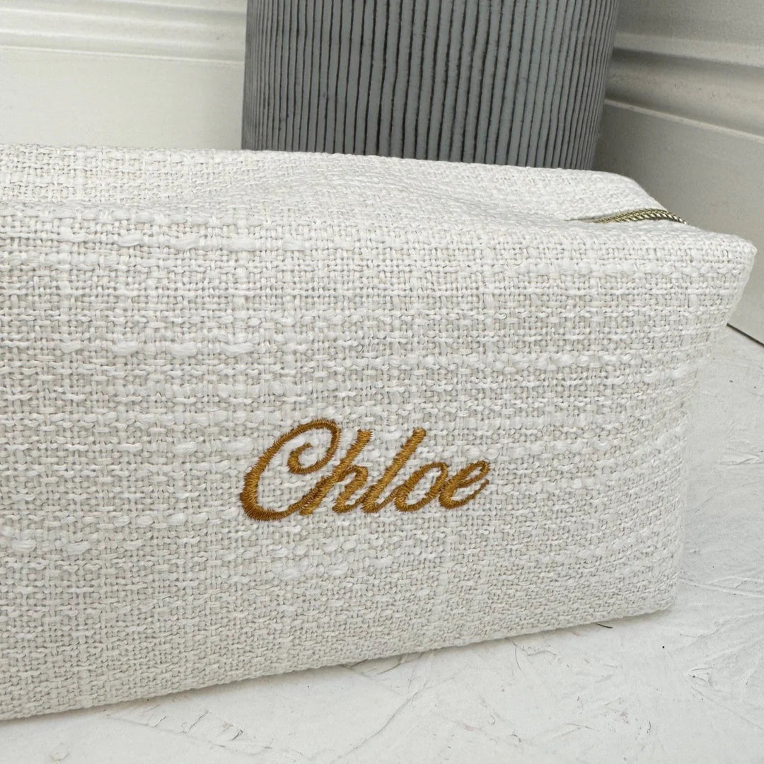 Textured pouch with 'Chloe' embroidery on a light background