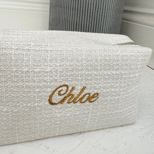 Textured pouch with 'Chloe' embroidery on a light background
