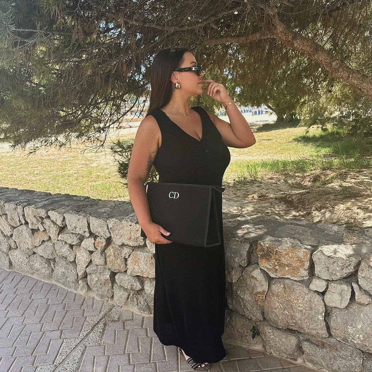 Woman holding personalised clutch bag with the initials on it CD