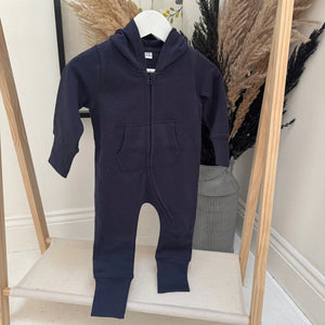 Navy blue baby onesie with a hood on a white hanger against a neutral background.