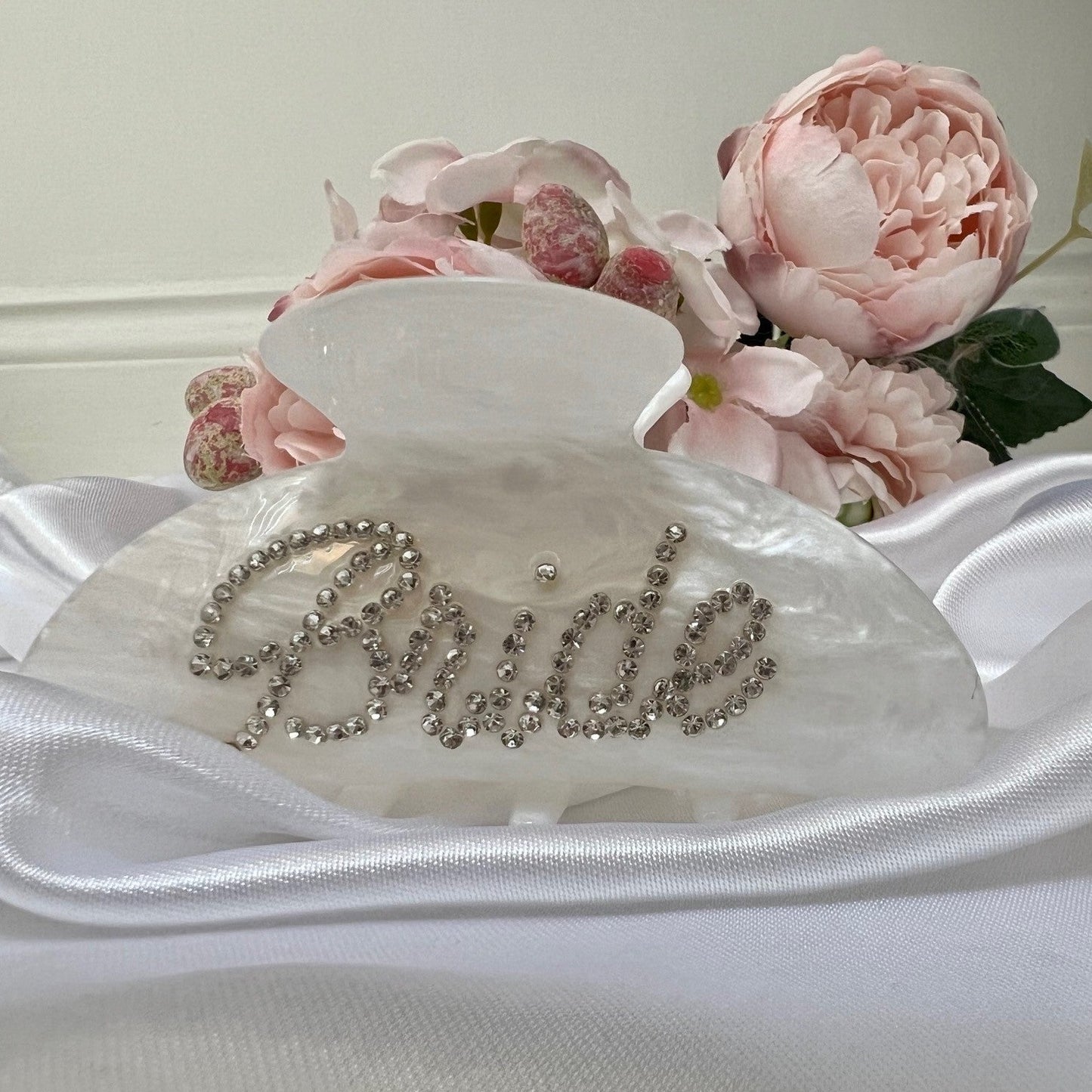 bridal hair clip infront of some flowers