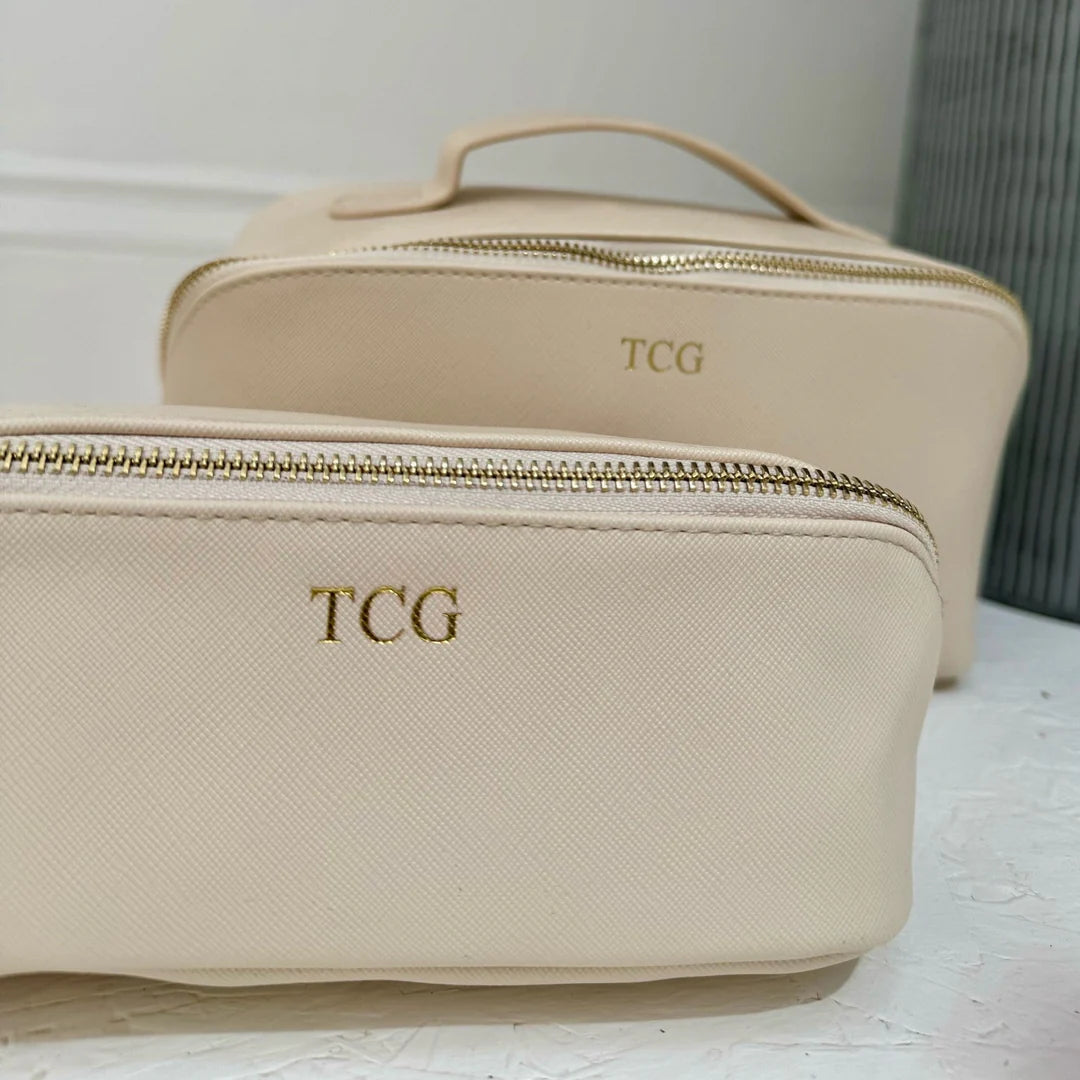 Beige toiletry bag with 'TCG' close up image
