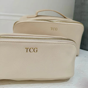 Beige toiletry bag with 'TCG' close up image