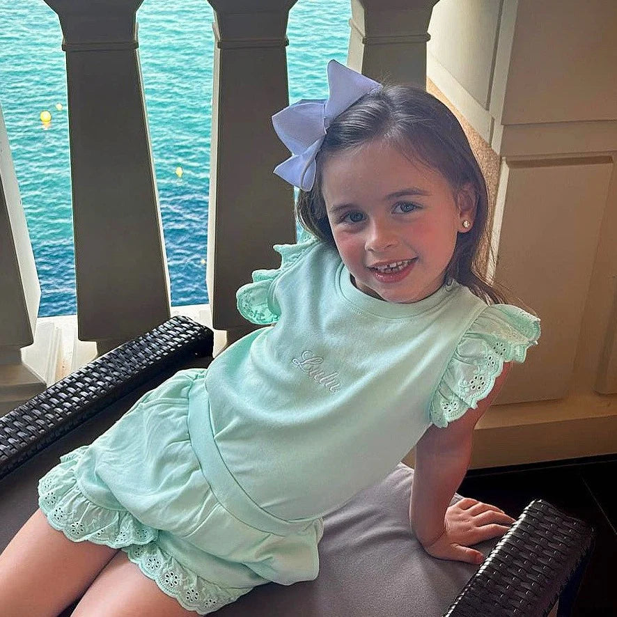 Young girl in short set with personalised name Lulu on it