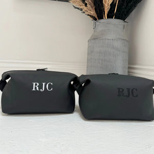 Two black toiletry bags with 'RJC' one with black and white personalisation