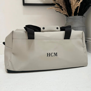 Grey weekend bag with black personalised initials on it 