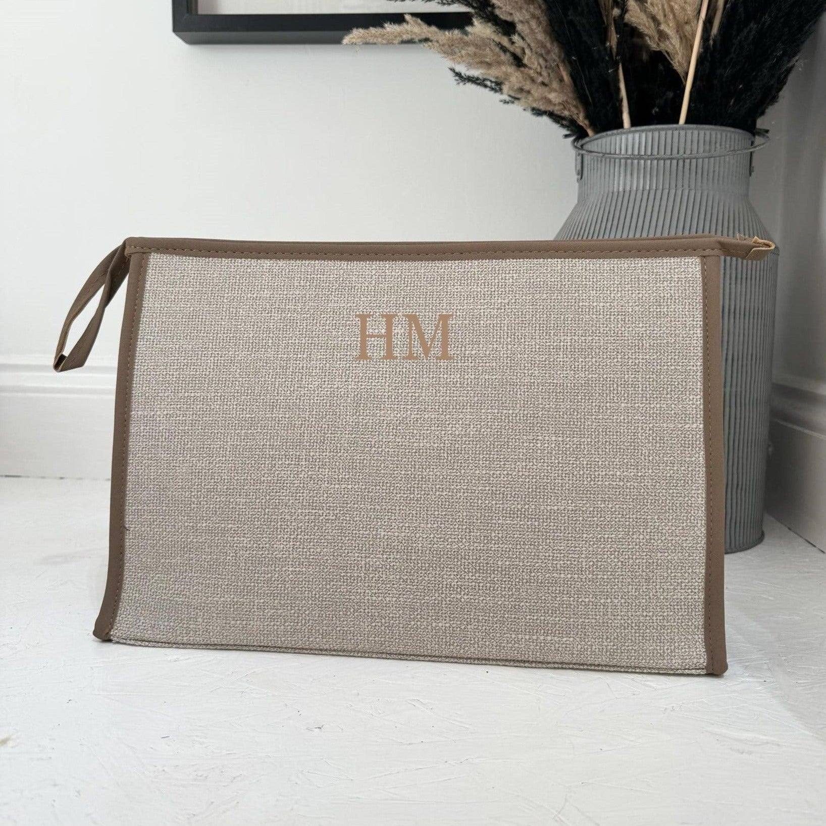 brown tote bag with initials HM on it
