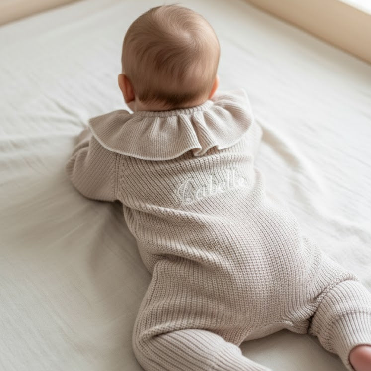 baby in baby romper with custom name on the back