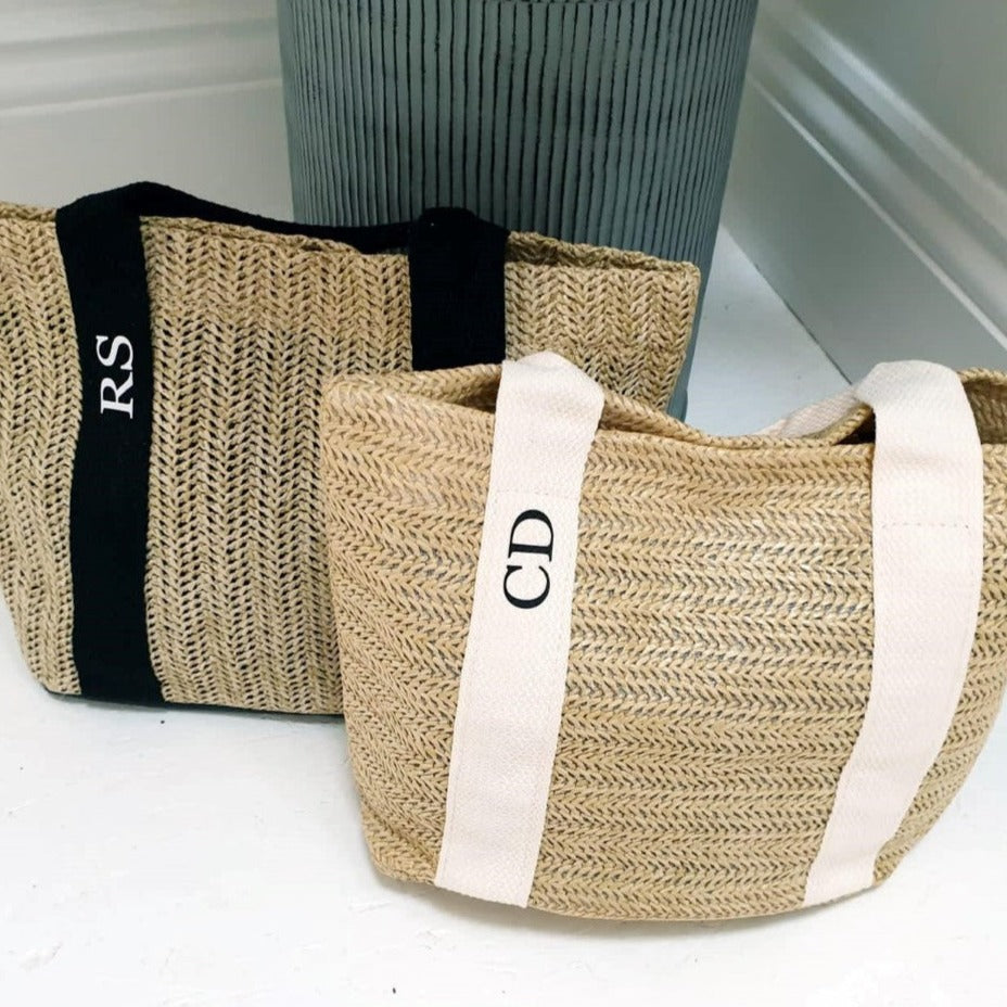 two personalised mini tote bags on white surface