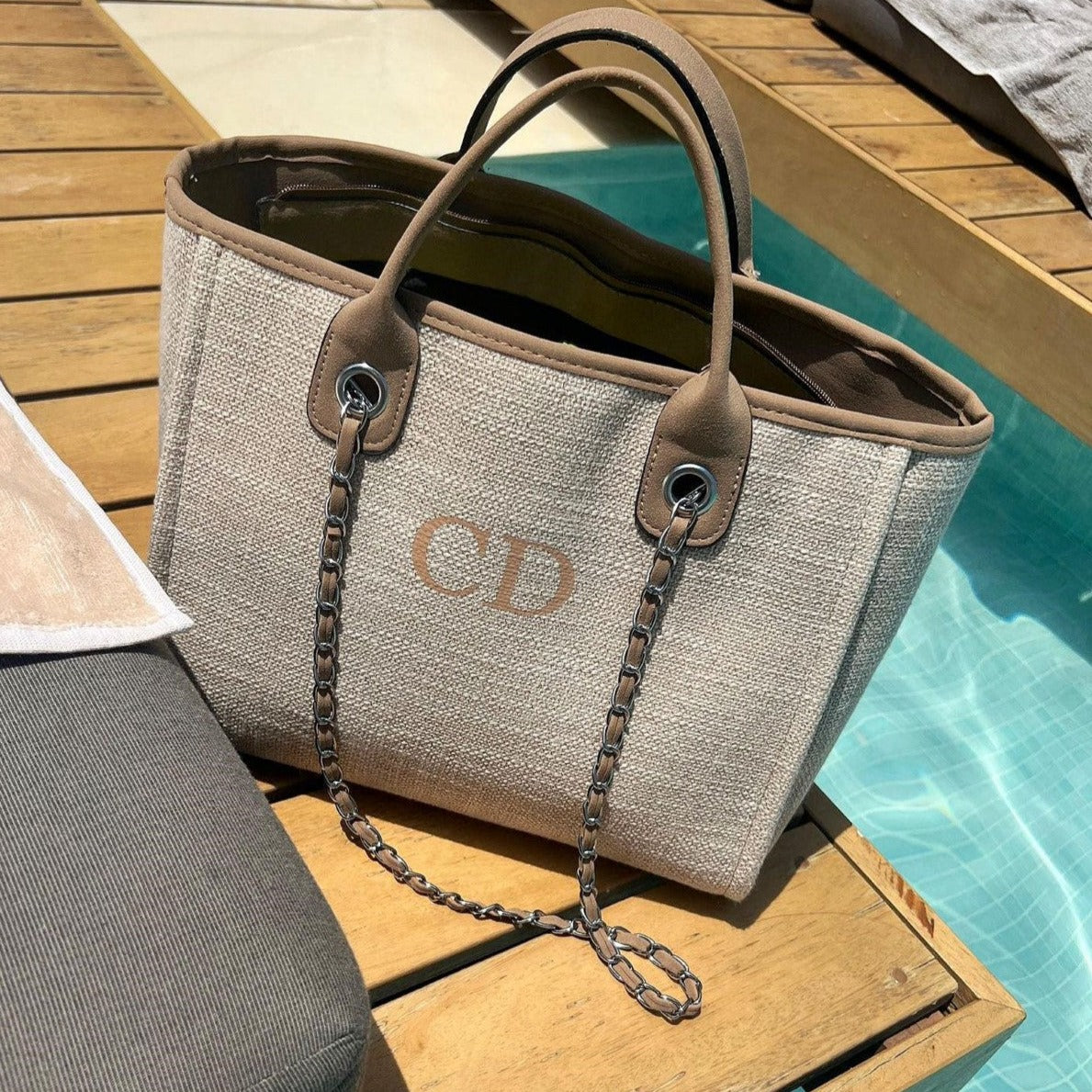 personalised brown tote bag by a pool